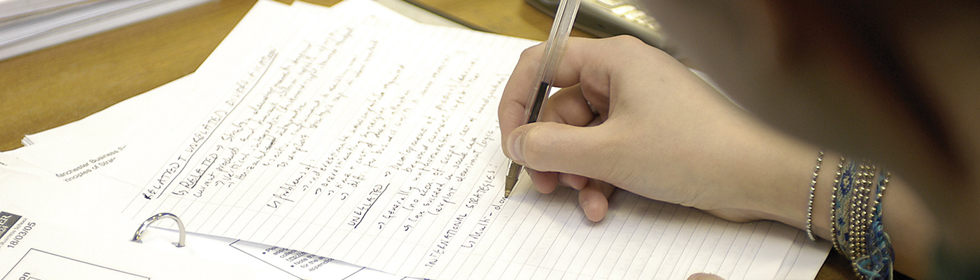 Researcher working on paper on a desk