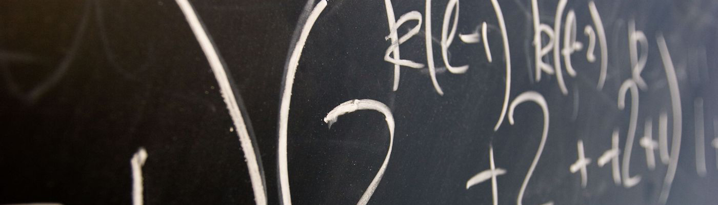 Close-up of algebraic equation on blackboard