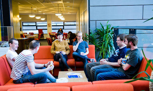 Postgraduate students talking on the PG common room sofas