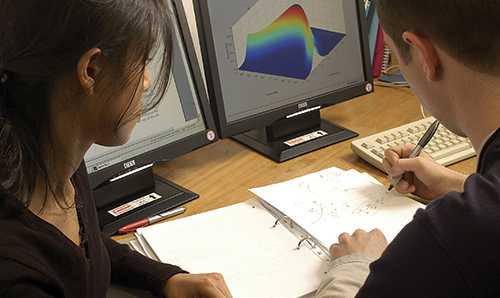 Students in conversation at a desk